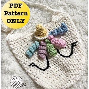 May include: Cream-colored crochet unicorn bag with a colorful horn and mane. The bag features a black embroidered smile and eyes. The text "PDF Pattern ONLY" is in a yellow circle. The Little Tickles logo is in the bottom left corner.