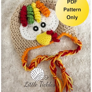 May include: Crochet pattern for a turkey hat with a brown body, white face, yellow beak, red wattle, and colorful feathers. The hat has a long, braided tie with red, yellow, and orange yarn. The pattern is available as a PDF download. "PDF Pattern Only" is written in yellow text on a yellow circle. The text "Little Tickles" is written in white text on a white circle with a swirl design.