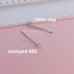 Peut inclure: Deux tiges d'oreille en argent avec des coupelles de 3 mm. Les tiges sont estampillées "585", ce qui indique qu'elles sont en or 14 carats.