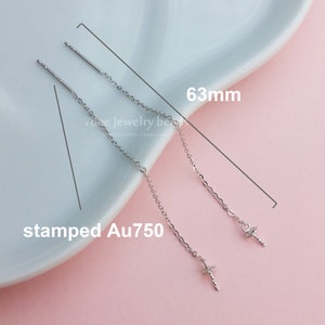 May include: Two silver earring posts with a 63mm chain attached to each post. The chain is made of 14k gold and is stamped Au750.