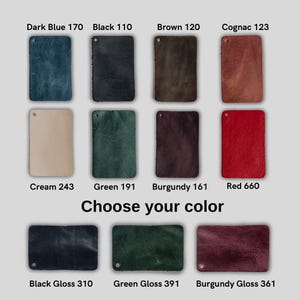 May include: A collection of rectangular leather swatches labeled Choose your color. The colors include Dark Blue 170, Black 110, Brown 120, Cognac 123, Cream 243, Green 191, Burgundy 161, Red 660, Black Gloss 310, Green Gloss 391, and Burgundy Gloss 361.