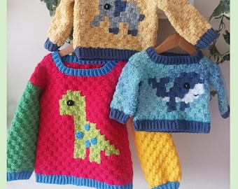 May include: Three crocheted jumpers featuring textured patterns and animal motifs. One yellow jumper displays a gray elephant, a red jumper features a green dinosaur, and a blue jumper shows a whale. Text reads C2C Jumper Boys PDF Crochet Pattern.