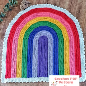 May include: A colorful rainbow crochet rug with a white crocheted border. The rug is made in the shape of a half circle and features a rainbow of colors, including red, orange, yellow, green, blue, indigo, and violet.