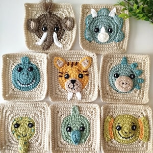 May include: A selection of handmade crochet squares, each depicting an animal face. The squares have a beige background and feature detailed animal designs, such as a brown elephant, a blue triceratops, a smiling blue dinosaur, and a yellow tiger. Ideal for a baby blanket or other craft project.