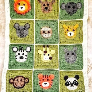 Peut inclure: Une couverture pour b&eacute;b&eacute; en crochet de couleur verte et blanche. La couverture pr&eacute;sente une vari&eacute;t&eacute; de visages d'animaux, dont un lion, une girafe, un z&egrave;bre, un panda, un singe et un tigre.