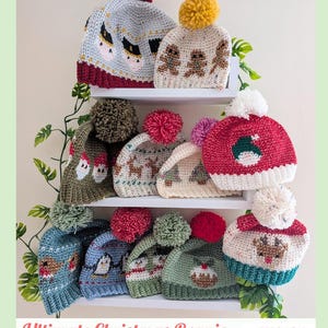 May include: A collection of twelve crocheted beanies with pom-poms, featuring various holiday-themed designs including reindeer, penguins, and gingerbread men. The text "Ultimate Christmas Beanie" and "PDF Crochet Pattern By Baby Crochet Designs" is visible.