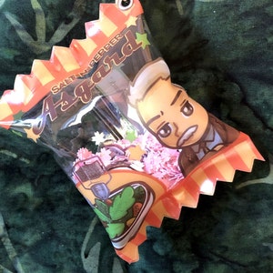 May include: A colorful candy-shaped keychain with a cartoon character and the text "Santen Pepper A-brand".