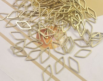 May include: A large pile of gold-colored metal diamond-shaped jump rings. The jump rings are all the same size and shape, and they are arranged in a random pattern.