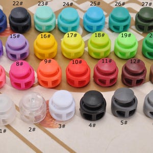 20 topes de cordón con botón, doble orificio, elásticos, para cordones de ropa, zapatos, mochilas y manualidades.