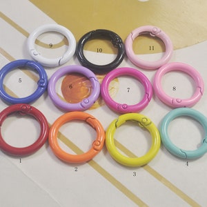 May include: Eleven colorful metal key rings with a snap closure. The rings are numbered 1 through 11. The colors are red, orange, yellow, light blue, dark blue, purple, pink, light pink, white, black, and light pink.
