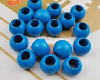 May include: A collection of 15 blue wooden beads with a hole in the center. The beads are round and smooth.
