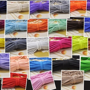 May include: Assortment of colorful elastic cord in various colors, including red, blue, green, yellow, purple, orange, pink, white, black, and brown. The elastic cord is arranged in rows and is ready to be used for crafting projects.