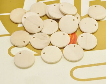 May include: A pile of 15 unfinished, round, wooden discs with a small hole in the center. The discs are light brown and have a smooth surface.
