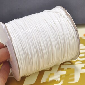 May include: A spool of white waxed cord, ideal for crafting and jewellery making.