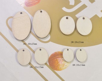 May include: Assortment of six unfinished wooden oval shapes with holes for hanging. The ovals are arranged in two rows. The sizes are labeled in millimeters: 40x25mm, 26x21mm, 22x17mm, and 18x14mm.