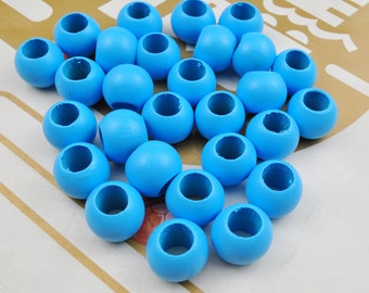 May include: A group of 25 light blue wooden beads with a hole in the center. The beads are arranged in a loose pile on a striped surface.