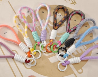 May include: A collection of ten colorful wrist straps with key rings. Each strap features a loop design in various colors, including pink, orange, yellow, and blue. The straps are numbered 1 through 10, and are suitable for keys or small accessories.