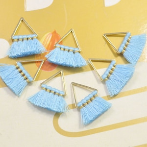 May include: Seven gold triangle-shaped charms with light blue tassel fringe.
