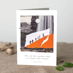 May include: Greeting card with a collage design showing figures climbing an orange mountain. The background features a waterfall and moon. The text reads: "It's not the mountain that we conquer, but ourselves." by Edmund Hillary.