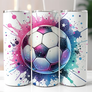 May include: A white stainless steel tumbler with a colorful watercolor design featuring a soccer ball. The design includes pink, blue, and green splatters and stars.