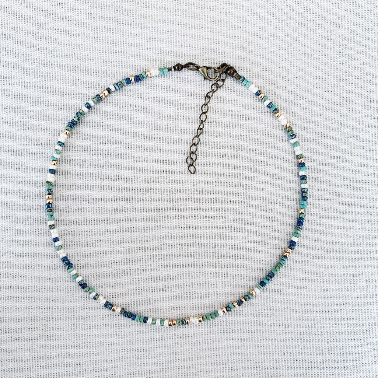 Minimal and dainty multicolor beaded choker with gold and shades of b…