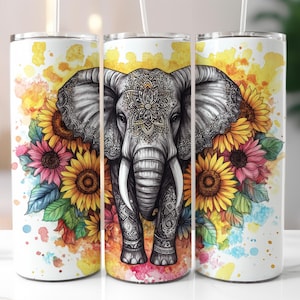 May include: A white tumbler featuring a detailed gray elephant design with intricate patterns. The elephant is surrounded by sunflowers and other colorful flowers. The background has watercolor splashes of yellow, orange, pink, and blue.