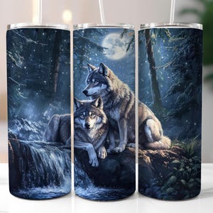 May include: A pair of grey wolves are nestled together in a forest setting. The wolves are in front of a waterfall and a full moon. The background is a dark blue with white stars.