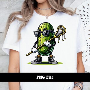 May include: A cartoon pickle wearing sunglasses and holding a lacrosse stick. The pickle is green and has a white face with a black mouth and eyes. The lacrosse stick is yellow and has a black net.