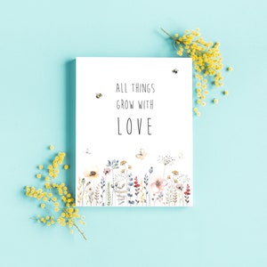 May include: A white card with the text "All things grow with love" and a watercolor illustration of a field of flowers and butterflies.