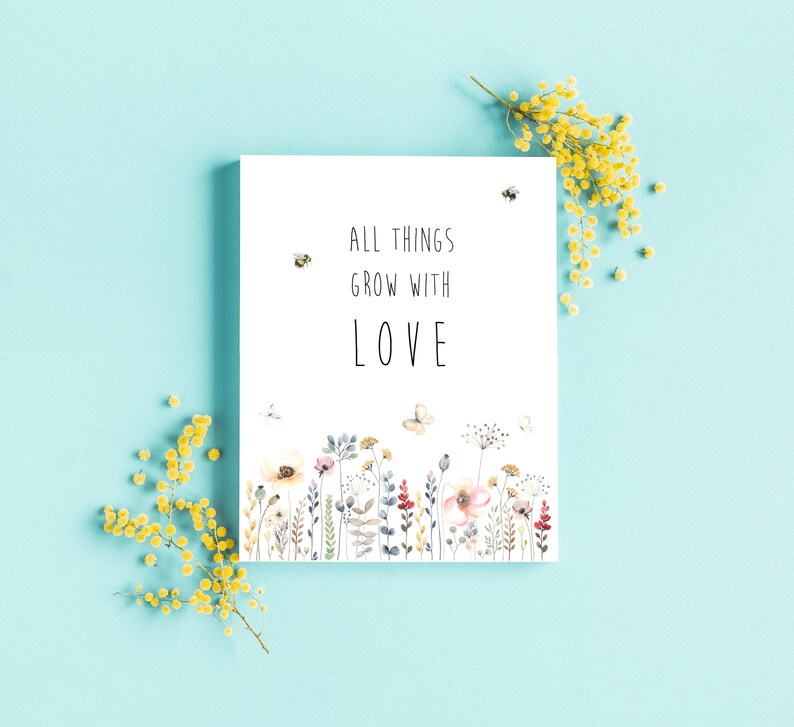 May include: A white card with the text "All things grow with love" and a watercolor illustration of a field of flowers and butterflies.
