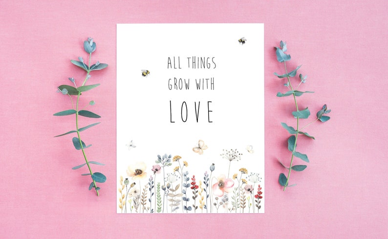 May include: A white card with the text "All things grow with LOVE" in black lettering. The card is decorated with a watercolor illustration of a field of wildflowers, butterflies, and bees.