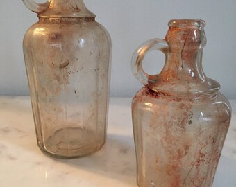 Set of 2 Vintage Clear Glass Jugs With Handles In Found Condition