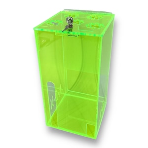 May include: A bright green acrylic box with a lock and key. The box has a small opening on the side.