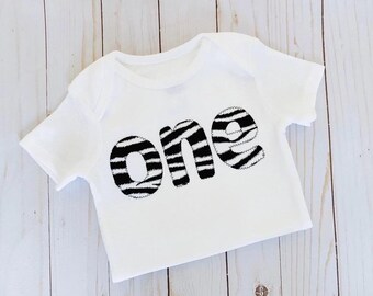 Body con estampado de cebra para bebé, número uno, para primer cumpleaños, camiseta de fiesta para niñas y niños en tonos neutros, estampado animal
