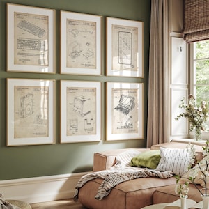 May include: Six framed vintage patent prints of tech devices, including a keyboard, a phone, and a computer, hang on a green wall. The prints are in gold frames and feature detailed technical drawings in black ink on a cream background.