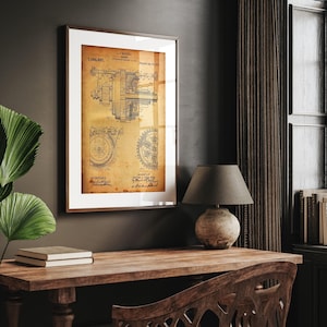 May include: Framed vintage patent print of a mechanical device, with detailed technical drawings in black ink on aged paper. The print is in a brown wooden frame, adding a classic touch to the wall decor. The text includes the patent number and inventor's name.