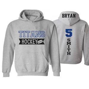 May include: Gray hooded sweatshirt with the text "Titans Hockey" and a hockey puck graphic on the front. The back of the sweatshirt has the text "BRYAN SMITH" and the number "5" in blue.