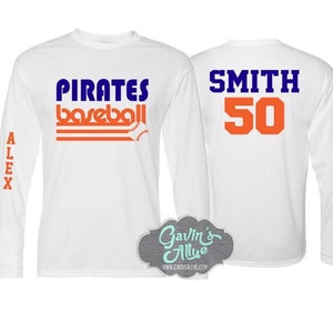 May include: Two white long-sleeved shirts with baseball themed designs. The front shirt has the text "PIRATES baseball" in blue and orange. The back shirt has the text "SMITH 50" in blue and orange.