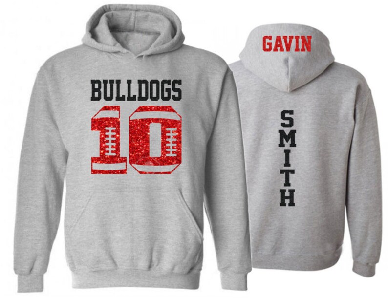 May include: Gray hooded sweatshirt with red glitter football number 10 and the word "BULLDOGS" on the front. The back of the sweatshirt has the name "GAVIN SMITH" printed vertically.