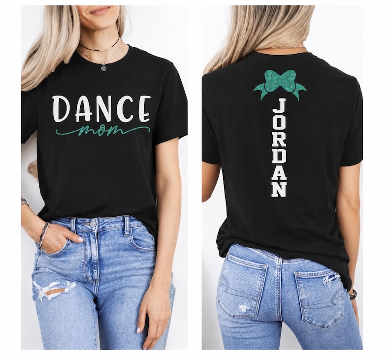 May include: A black short-sleeve t-shirt featuring the white text DANCE and the teal cursive text mom on the front. The back of the shirt displays a teal glittery bow graphic above the white vertical text JORDAN in a bold block font.