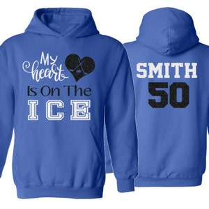 May include: A royal blue hoodie with a white graphic that says "My heart is on the ICE" with a black heart and hockey sticks. The back of the hoodie has a white graphic that says "SMITH 50".