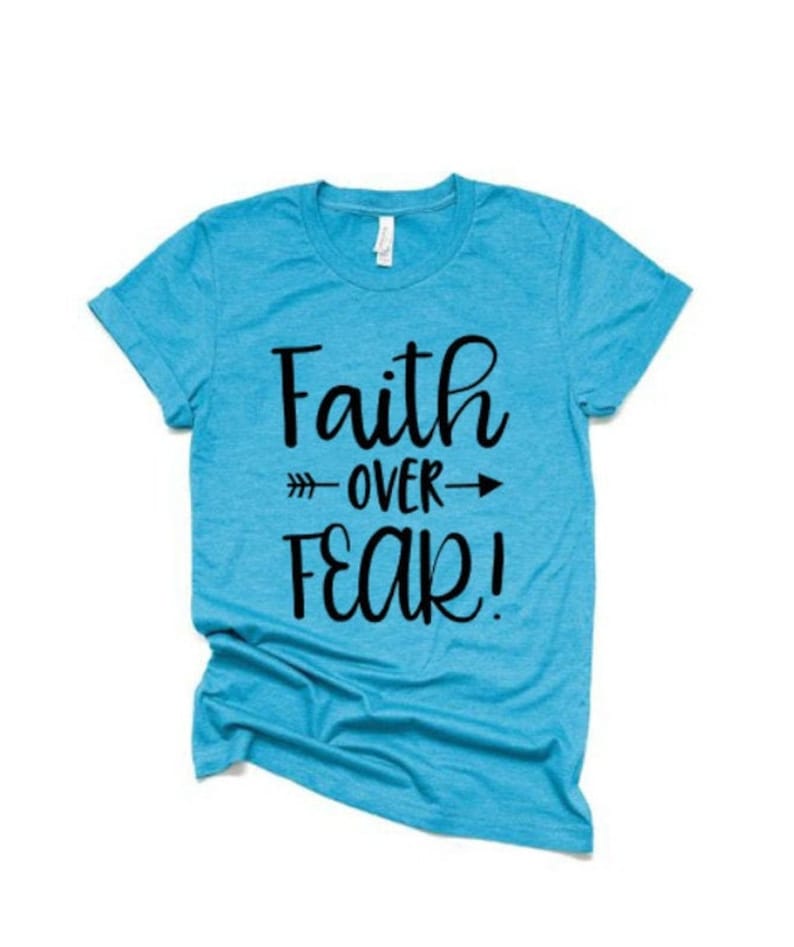 May include: A turquoise blue t-shirt with the text "Faith over Fear!" printed in black.