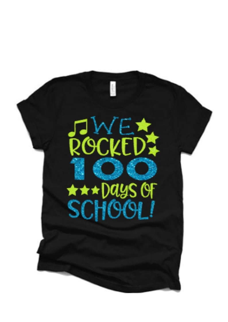 May include: Black t-shirt with a green and blue glitter design that says "We rocked 100 days of school!"