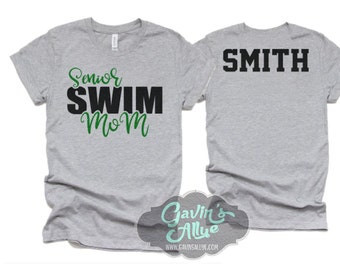 May include: Two gray t-shirts, one with the text "Senior Swim Mom" in black and green lettering, and the other with the text "SMITH" in black lettering.