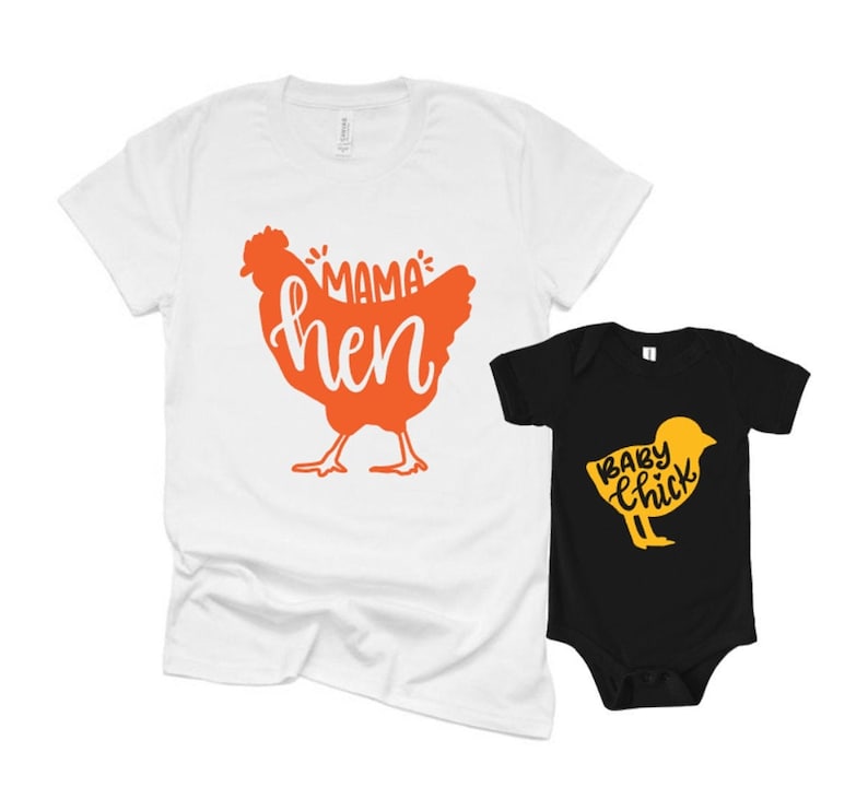 May include: Two matching shirts. A white t-shirt with an orange hen graphic and the words "Mama Hen". A black baby onesie with a yellow chick graphic and the words "Baby Chick".
