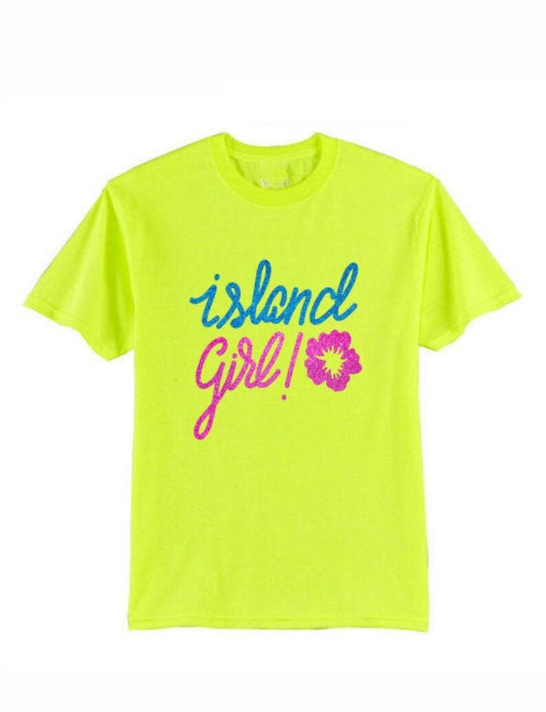May include: Neon yellow t-shirt with the text "island girl!" in blue, pink, and white glitter lettering. A pink glitter flower is next to the text.