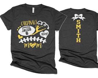 May include: Two gray t-shirts with a yellow and white design. The front shirt says "Cardinals" with a football, a dancer, and the text "Jacob 6" and "Allye". The back shirt says "SMITH" with a football-shaped bow.