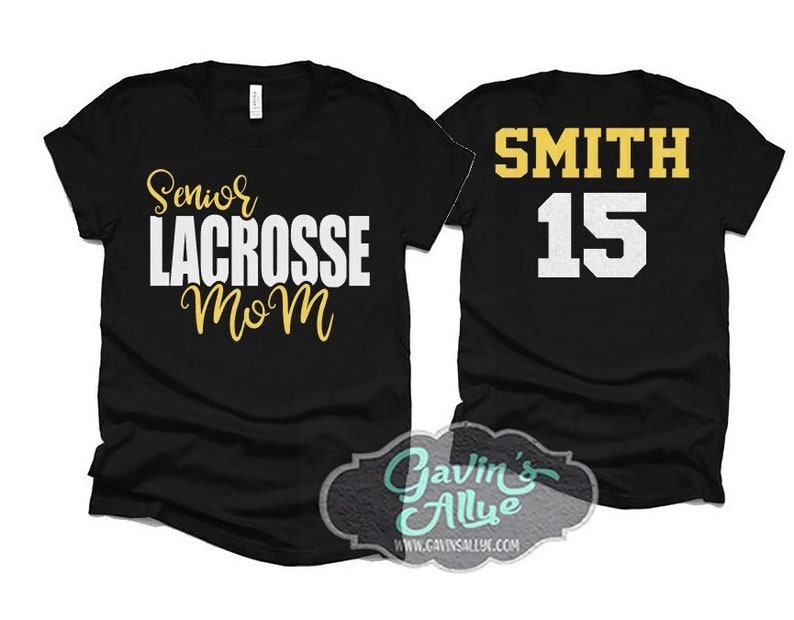 May include: Two black t-shirts. One shirt says "Senior Lacrosse Mom" in gold and white lettering. The other shirt says "Smith 15" in gold and white lettering.