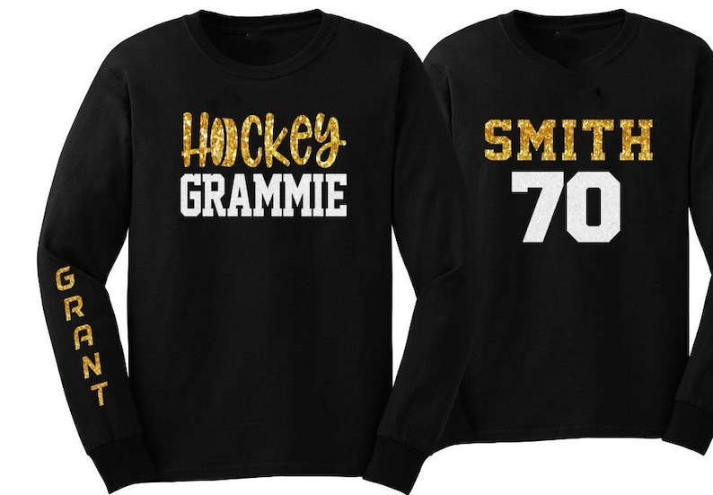 May include: Two black long-sleeved shirts with gold glitter lettering. One shirt says "Hockey Grammi" and the other says "Smith 70".