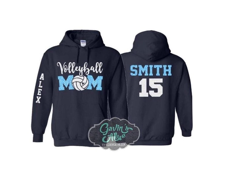 May include: Two navy blue hooded sweatshirts. One sweatshirt has the text "Volleyball Mom" with a volleyball graphic and the text "ALEX" on the sleeve. The other sweatshirt has the text "SMITH 15" on the back.